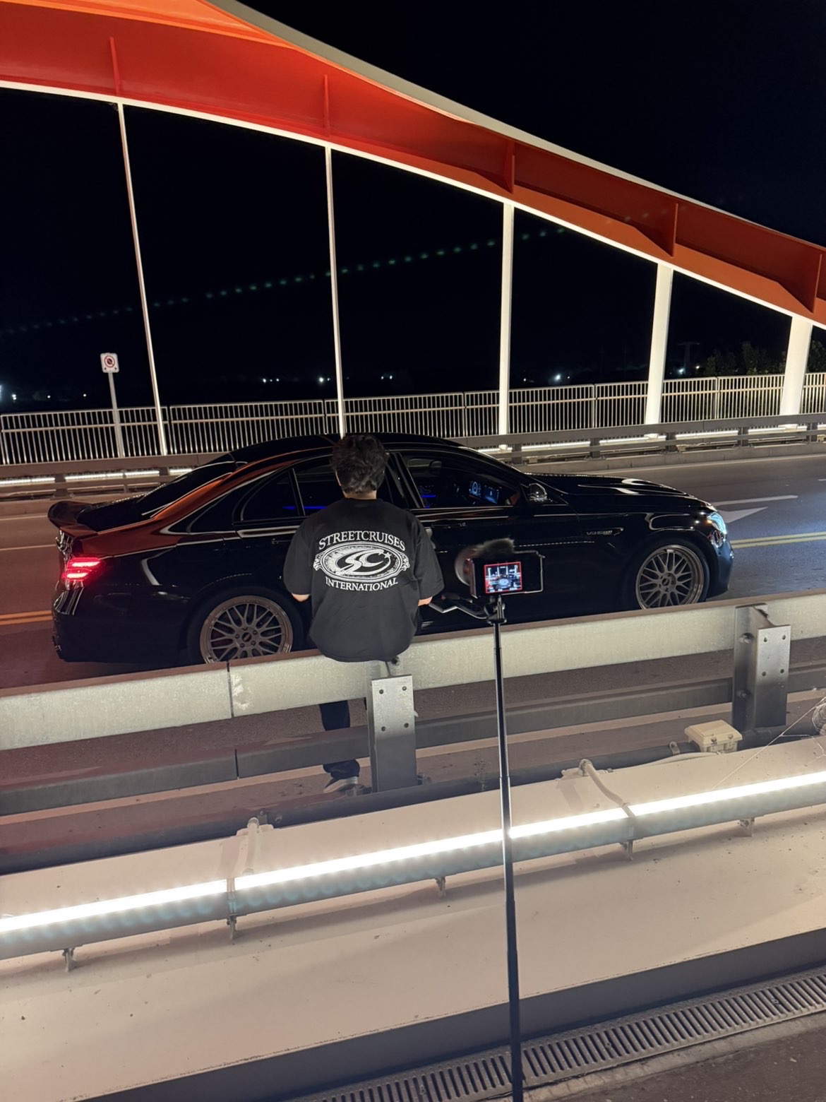 Streetcruises founder wearing the brand while filming automotive content